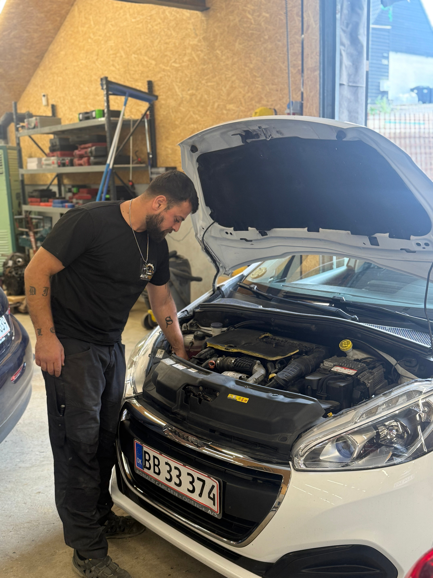 Mekaniker udfører fejlfinding på motor i Peugeot 208 i Tebstrup
